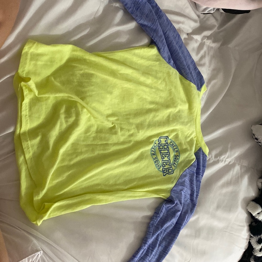 A cheer squad long sleeve shirt. Neon yellow and light blue.